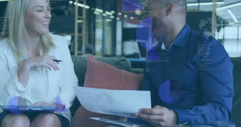 Diverse Business Colleagues Discussing Data with Overlayed Graphs