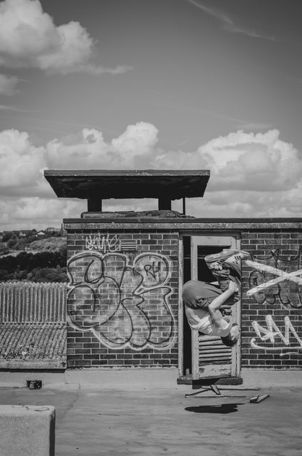 Young Man Performing Parkour Flip on Rooftop - Download Free Stock Images Pikwizard.com