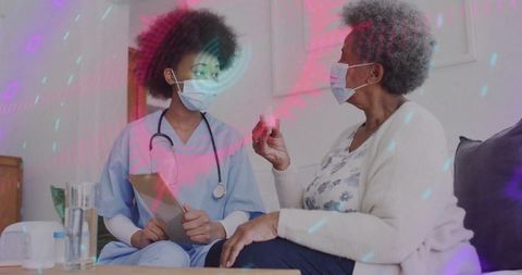 Nurse advising senior patient at home with medication guidance