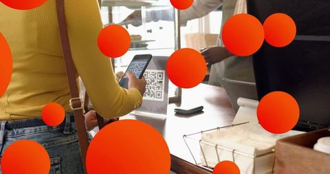 Woman in cafe scanning qr code for cashless payment