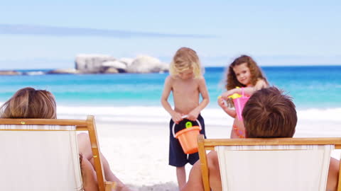 Children Playing with Buckets on Beach