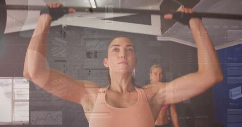Focused woman pulling up on bar, exercising strength and determination
