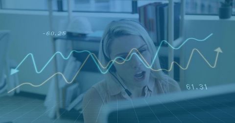 Customer Service Agent Speaking with Headset Analyzing Data Overlays at Office Monitor