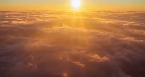 Golden Sunrise Illuminating Clouds in Majestic Aerial View