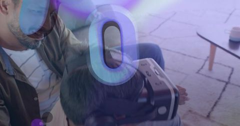 Father adjusting vr headset on son in cozy living room with holographic overlay, bonding