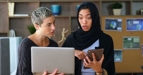Diverse Female Business Colleagues Collaborating on Project