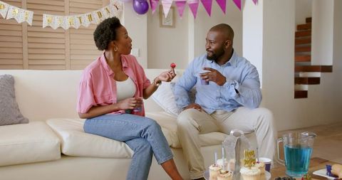 African American Couple Celebrating Birthday at Home Sharing Cupcakes and Conversation