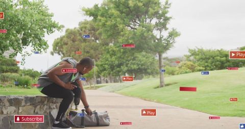 Amputee Athlete Engaged with Social Media Icons in Park - Download Free Stock Images Pikwizard.com