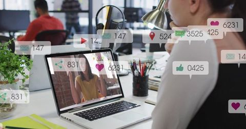 Coworking professional joining video call with social notifications on laptop