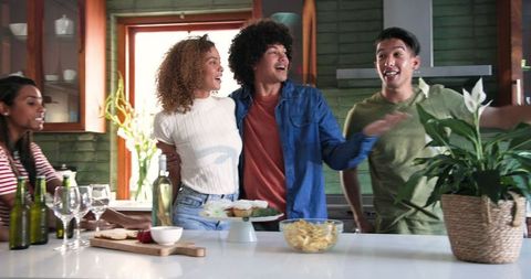 Excited Friends Reuniting in Modern Kitchen