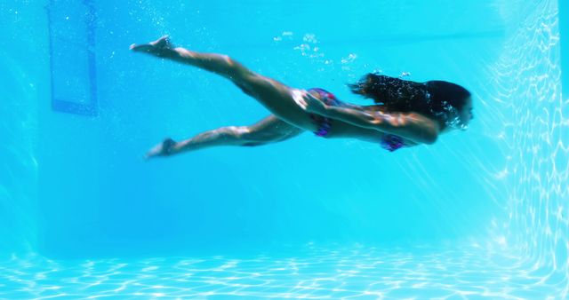 Woman Swimming Underwater in Bright Blue Pool - Download Free Stock Images Pikwizard.com