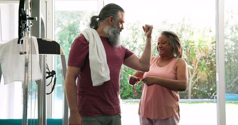 Senior Couple Engaging in Home Fitness Routine with Joyful Expressions