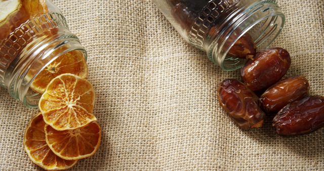 Dried Citrus Slices and Dates in Glass Jars on Burlap Fabric - Download Free Stock Images Pikwizard.com