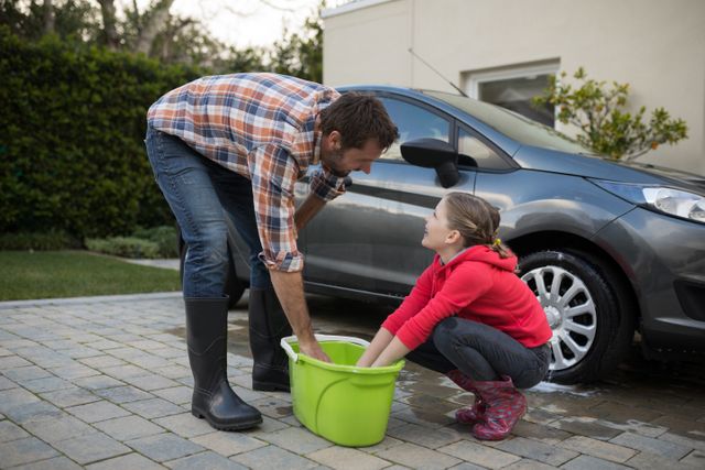 Teenage girl and father washing a car - Download Free Stock Photos Pikwizard.com