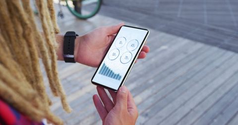 Man Analyzing Phone Statistics with Dreadlocks in Outdoor Setting - Download Free Stock Images Pikwizard.com