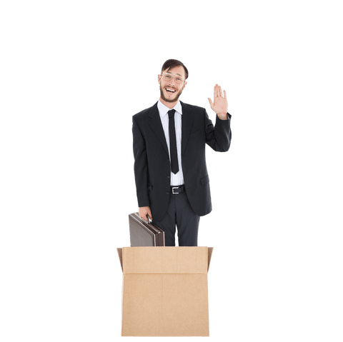 Shot features happy businessman waving while standing in cardboard box. Concept emphasizes creativity and thinking outside the box. Suitable for business topics like innovation, leadership, and unconventional solutions in articles, blogs, or presentations.