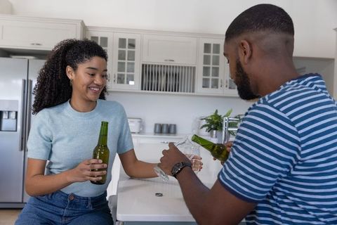 Couple Relaxing with Beer in Modern Kitchen Setting