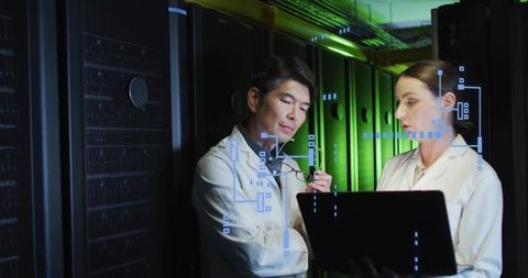 IT engineers reviewing server diagnostics on laptop in data center aisle with HUD overlay