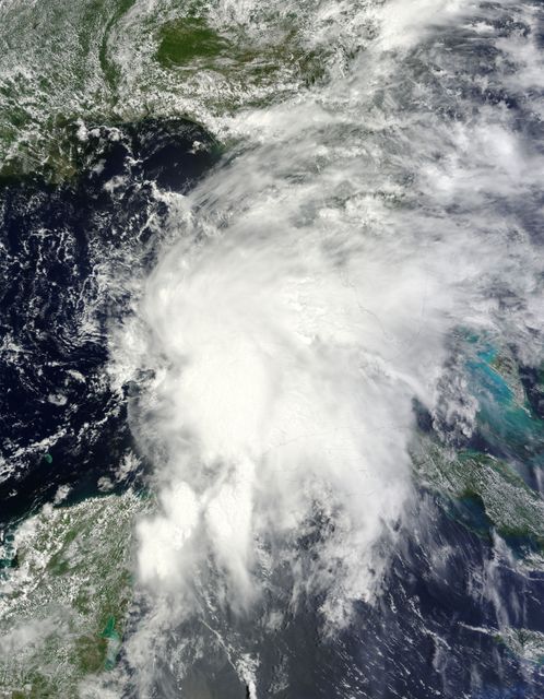 NASA’s Terra satellite passed over Tropical Storm Andrea on June 5 at 16:25 UTC (12:25 p.m. EDT) and the MODIS instrument captured this visible image of the storm. Andrea’s clouds had already extended over more than half of Florida.    Credit: NASA Goddard MODIS Rapid Response Team  ---  NASA Sees Heavy Rainfall in Tropical Storm Andrea  NASA’s TRMM satellite passed over Tropical Storm Andrea right after it was named, while NASA’s Terra satellite captured a visible image of the storm’s reach hours beforehand. TRMM measures rainfall from space and saw that rainfall rates in the southern part of the storm was falling at almost 5 inches per hour.  NASA’s Terra satellite passed over Tropical Storm Andrea on June 5 at 16:25 UTC (12:25 p.m. EDT) and the Moderate Resolution Imaging Spectroradiometer or MODIS instrument, captured a visible image of the storm. At that time, Andrea’s clouds had already extended over more than half of Florida.  At 8 p.m. EDT on Wednesday, June 5, System 91L became the first tropical storm of the Atlantic Ocean hurricane season. Tropical Storm Andrea was centered near 25.5 North and 86.5 West, about 300 miles (485 km) southwest of Tampa, Fla. At the time Andrea intensified into a tropical storm, its maximum sustained winds were near 40 mph (65 kph).  Full updates can be found at NASA's Hurricane page: <a href="http://www.nasa.gov/hurricane" rel="nofollow">www.nasa.gov/hurricane</a>  Rob Gutro NASA’s Goddard Space Flight Center