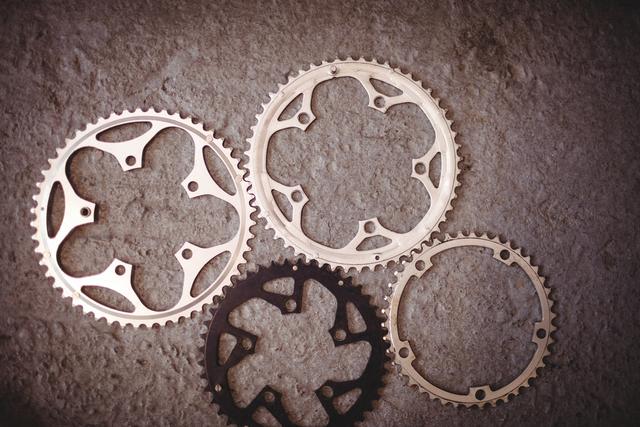 Assorted Bicycle Gears on Workshop Floor - Download Free Stock Photos Pikwizard.com