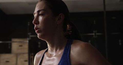 Sweaty Fit Woman Resting After Intense Workout in Gym