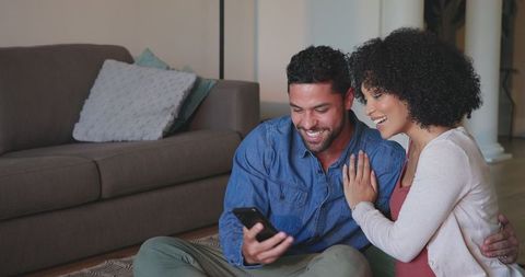 Happy Couple Smiling while Taking Selfie on their Living Room Floor