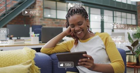 Smiling African American Woman Engaging with Social Media Data in an Office