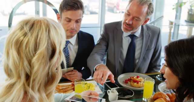 Business Professionals Discussing Work Over Breakfast Meeting - Download Free Stock Images Pikwizard.com