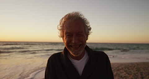 Smiling Senior Man on Beach at Sunset