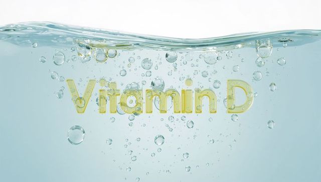 Floating Vitamin D text rising in clear water with bubbles and light refraction