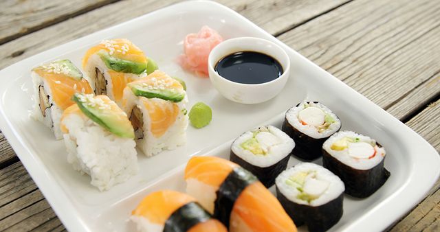 Assorted Sushi Rolls and Nigiri on White Plate with Soy Sauce - Download Free Stock Images Pikwizard.com