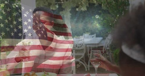 Women enjoying outdoor meal with american flag overlay