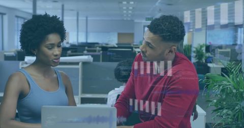 Diverse Colleagues Collaborating in Modern Office with Digital Data Overlay