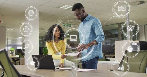 Collaborative team reviewing digital strategy with augmented UI in modern open-plan office