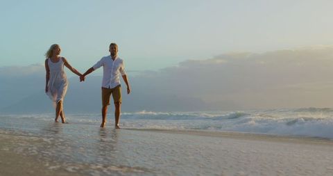 Romantic Couple Strolling on a Secluded Beach at Sunset