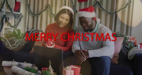 Smiling couple celebrating Christmas on cozy virtual call wearing Santa hats and sweaters