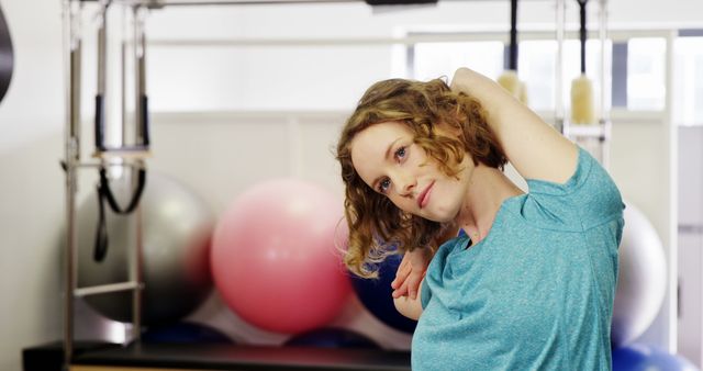 Young Woman Stretching Neck During Fitness Routine at Gym - Download Free Stock Images Pikwizard.com