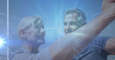 Mature couple dancing with futuristic holograms in blue glow