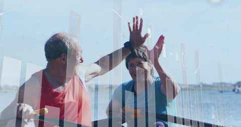 Senior couple high-fiving rowing on lake with data visualization overlay active aging