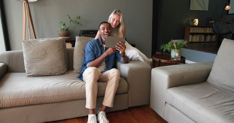 Happy Couple Sharing Engagement News at Home