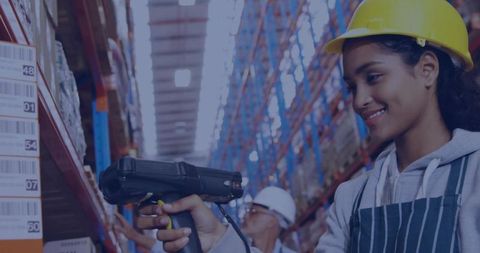 Warehouse Worker Scanning Barcodes with Handheld Scanner in Aisle Wearing Hard Hat