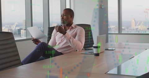 Senior Executive Analyzing Financial Data in Modern Office Space
