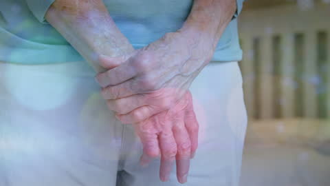 Elderly Hands in Gentle Light Reflection