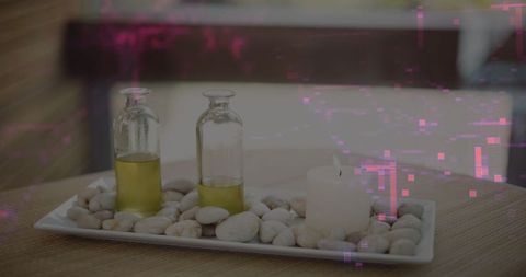 Serene Spa Setup with Aromatic Oil and Candle on Pebble Tray