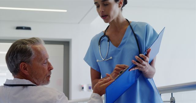 Doctors Discussing Patient Medical Records in Hospital Corridor - Download Free Stock Images Pikwizard.com