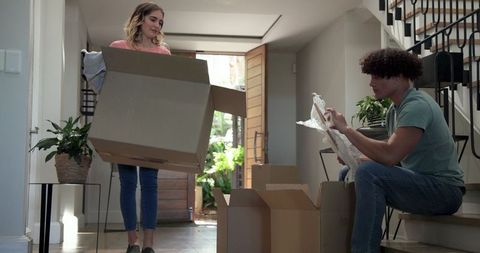 Happy couple unpacking and organizing in new home