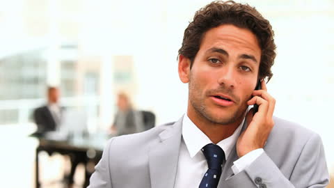 Executive in Formal Suit Engaging in Business Call