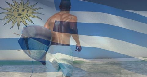 Uruguay flag overlay surfer standing at shore carrying surfboard patriotic beach lifestyle