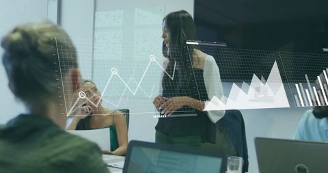 Business Woman Presenting Data Visualization in Office Meeting