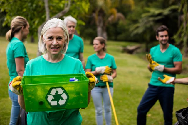 Portrait of recycling team member standing in park